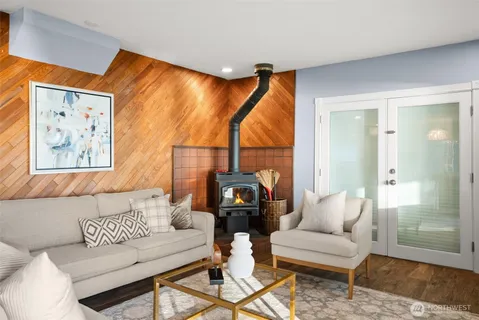 a living room with furniture and a painting on the wall
