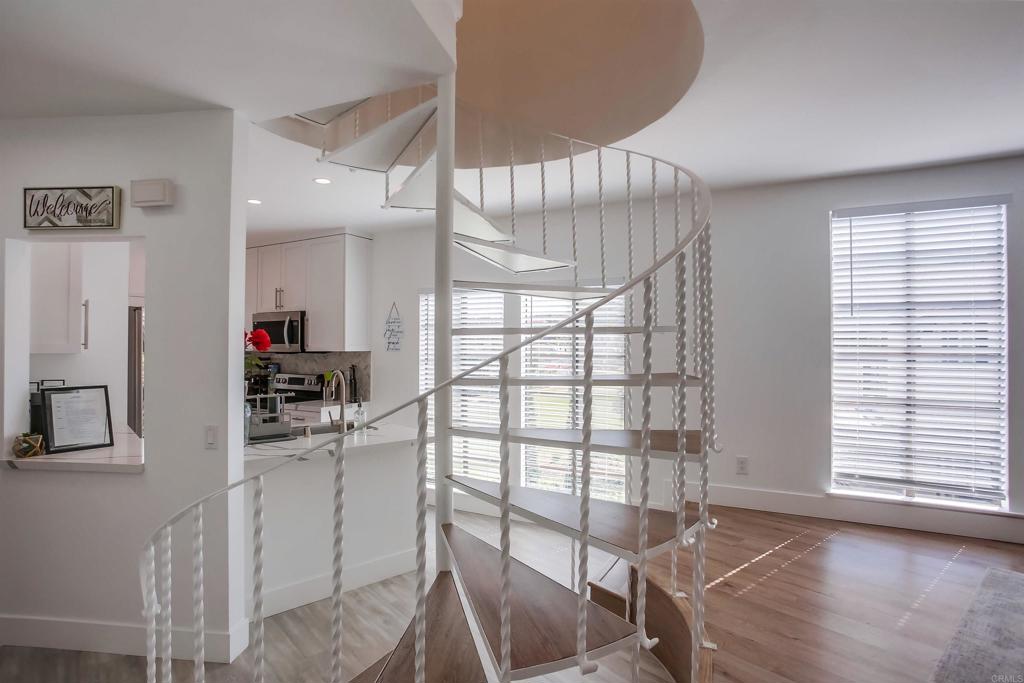 2630 Pirineos Way, Unit 11 Carlsbad, CA 92009 - Photo 11 of 28 a kitchen with granite countertop a table chairs refrigerator and a window
