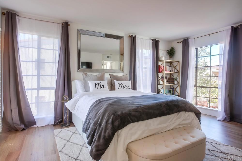 2630 Pirineos Way, Unit 11 Carlsbad, CA 92009 - Photo 17 of 28 a bedroom with a large bed and a window