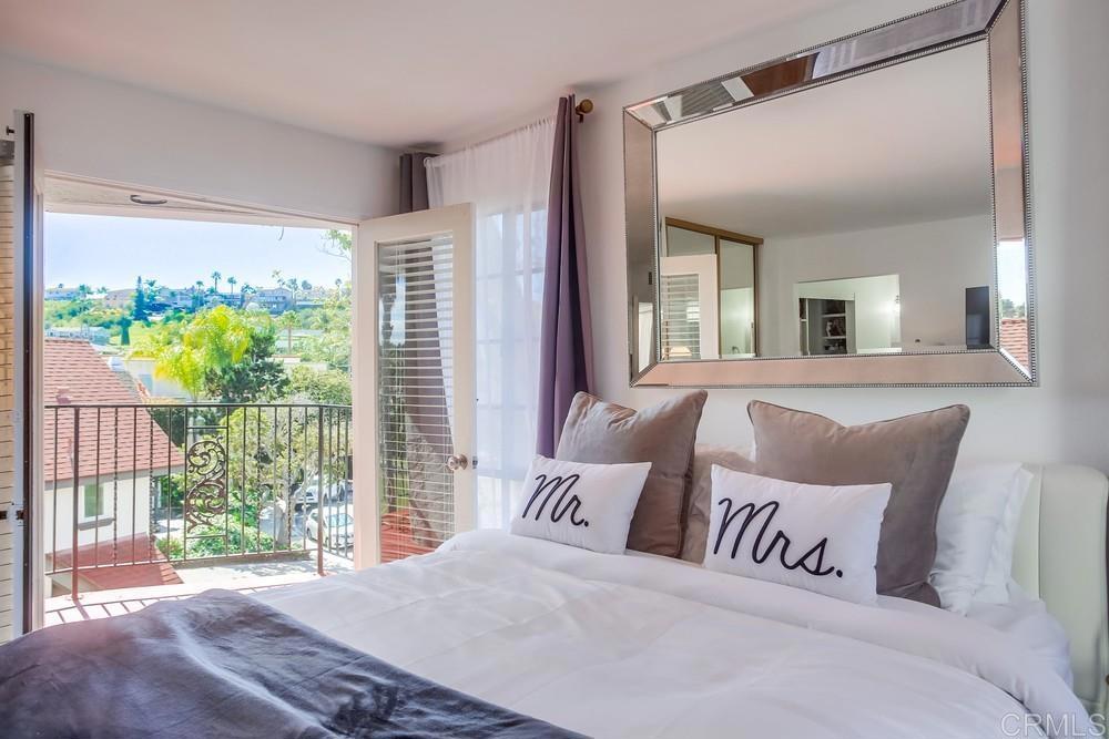 2630 Pirineos Way, Unit 11 Carlsbad, CA 92009 - Photo 18 of 28 a view of a bedroom with a large window and swimming pool