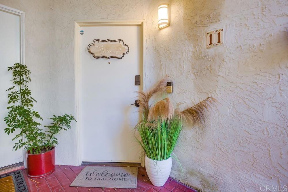 2630 Pirineos Way, Unit 11 Carlsbad, CA 92009 - Photo 2 of 28 a vase of flowers sitting on a table