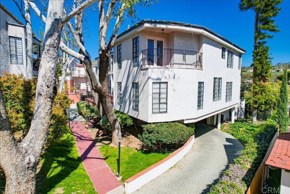 2630 Pirineos Way, Unit 11 Carlsbad, CA 92009 - Photo 26 of 28 a front view of a house with a yard