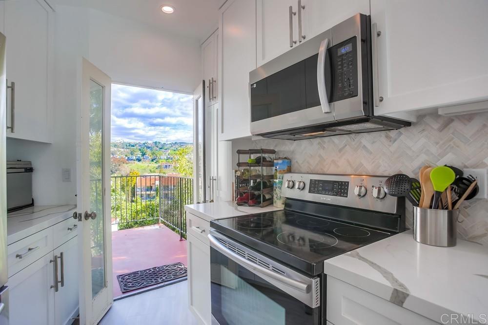 2630 Pirineos Way, Unit 11 Carlsbad, CA 92009 - Photo 7 of 28 a kitchen with a stove and a microwave
