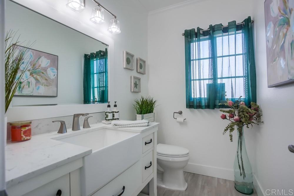 2630 Pirineos Way, Unit 11 Carlsbad, CA 92009 - Photo 10 of 28 a bathroom with a toilet sink and mirror