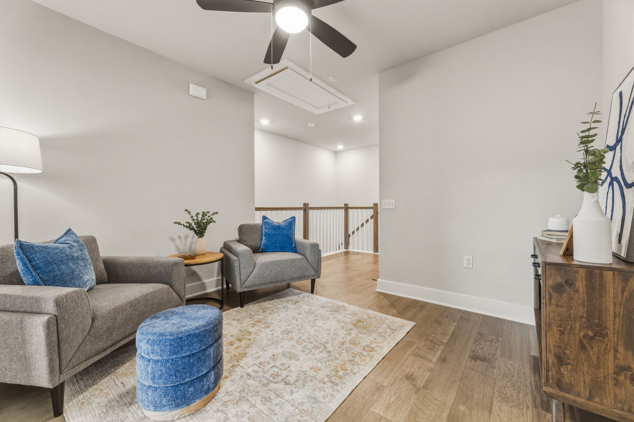 2929 Moreno Street Austin, TX 78723 - Photo 25 of 40 Open living area featuring light-toned walls, wood-finish flooring, and a ceiling fan