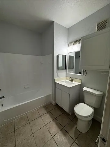 a bathroom with a sink mirror vanity and toilet