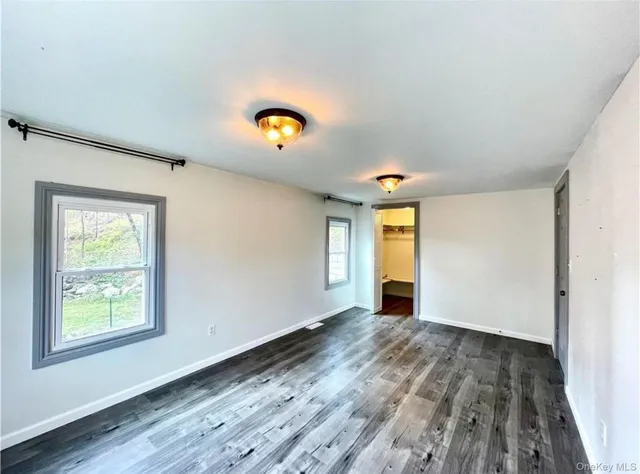 wooden floor in an empty room with a window