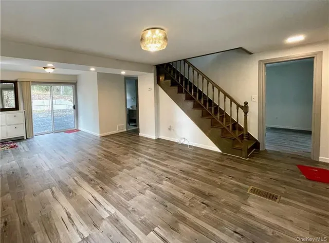 a view of an entryway with wooden floor