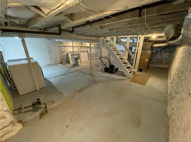 a view of a garage with white cabinets