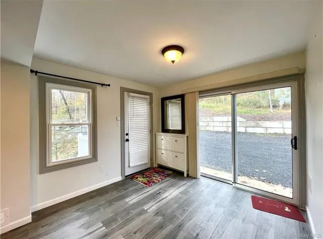 a view of room with window and wooden floor