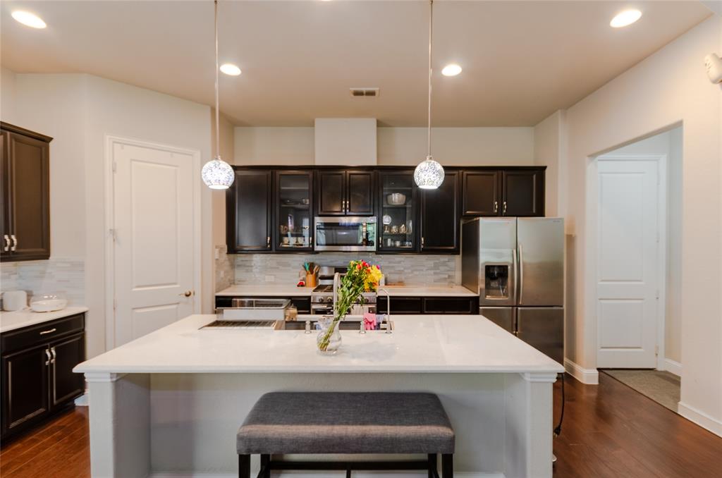 1448 Pebble Way Allen, TX 75013 - Photo 3 of 25 a kitchen with kitchen island a sink appliances and cabinets