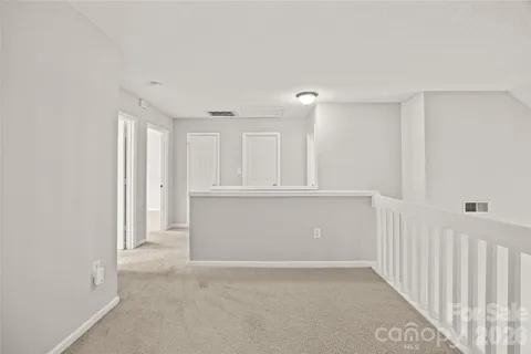 a view of kitchen with white cabinets