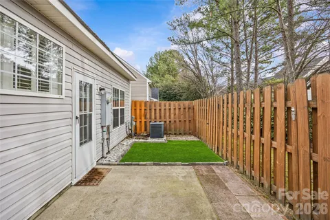 a view of a backyard with wooden fence