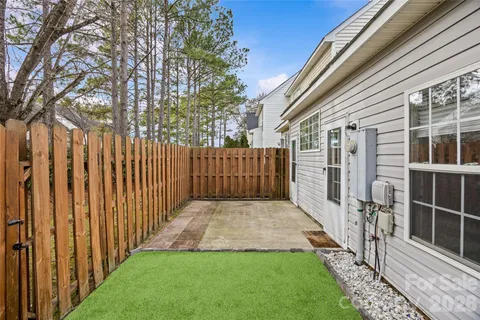 a view of a backyard with wooden fence