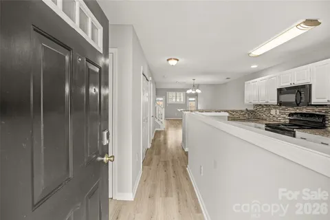 a kitchen with stainless steel appliances granite countertop a refrigerator a stove and a sink