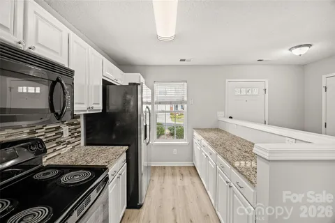 a kitchen with stainless steel appliances granite countertop a stove and a refrigerator