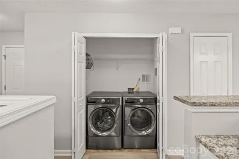 a utility room with sink dryer and washer