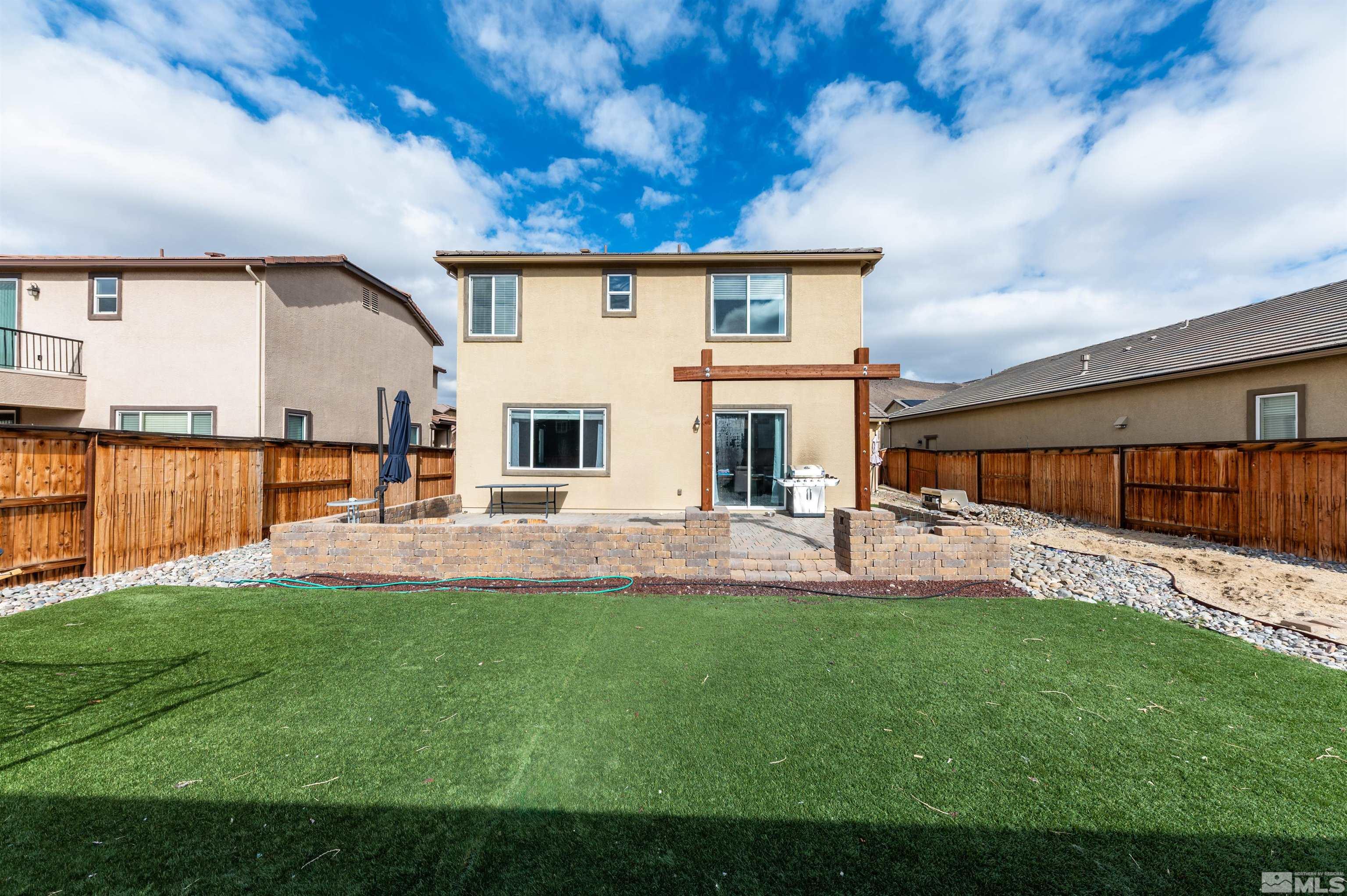 2980 Show Jumper Lane Reno, NV 89521 - Photo 13 of 15 a view of house with backyard and swimming pool