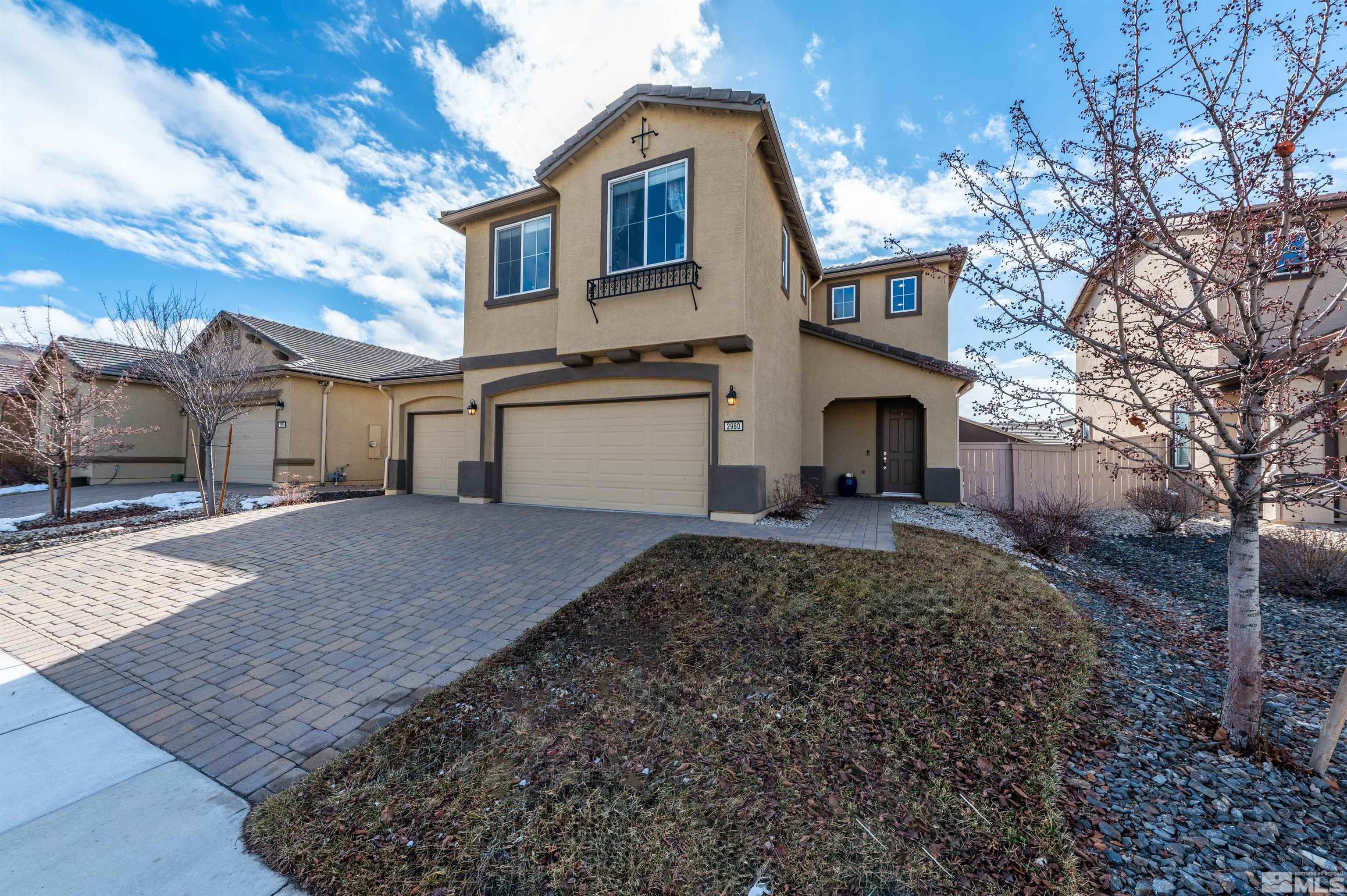 2980 Show Jumper Lane Reno, NV 89521 - Photo 2 of 15 a front view of a house with a yard and garage