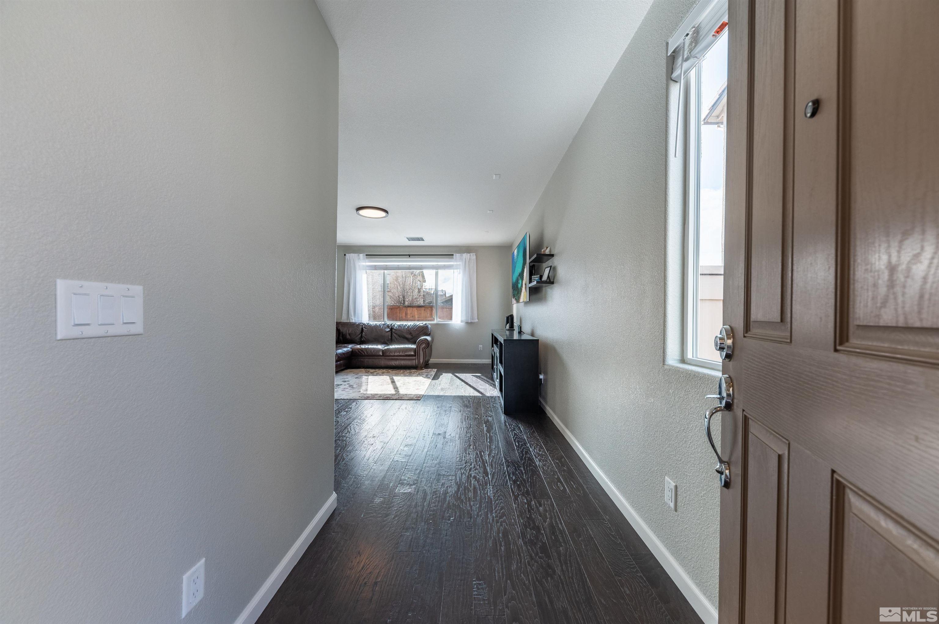 2980 Show Jumper Lane Reno, NV 89521 - Photo 3 of 15 a view of a hallway with wooden floor and furniture