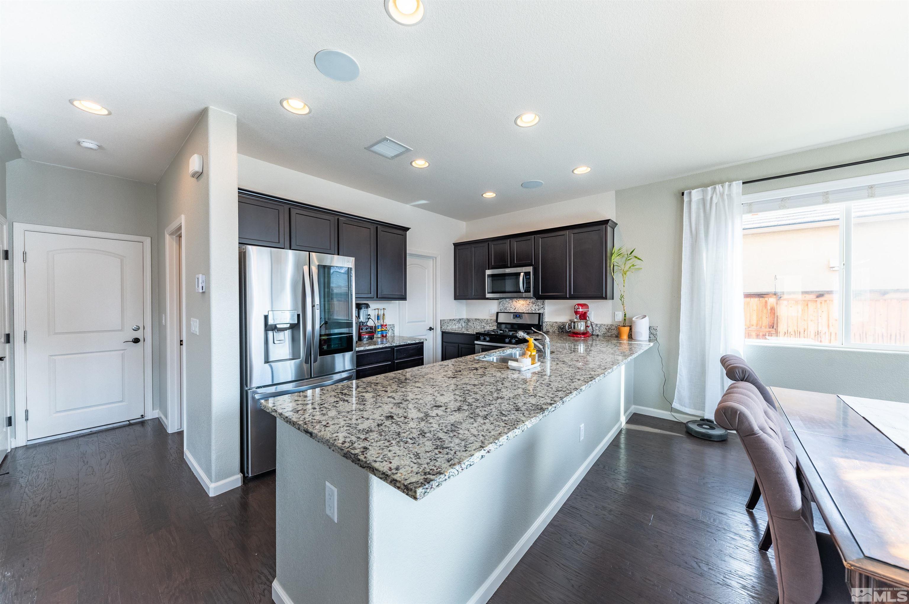 2980 Show Jumper Lane Reno, NV 89521 - Photo 5 of 15 a large kitchen with kitchen island a large counter top space a sink stainless steel appliances and cabinets