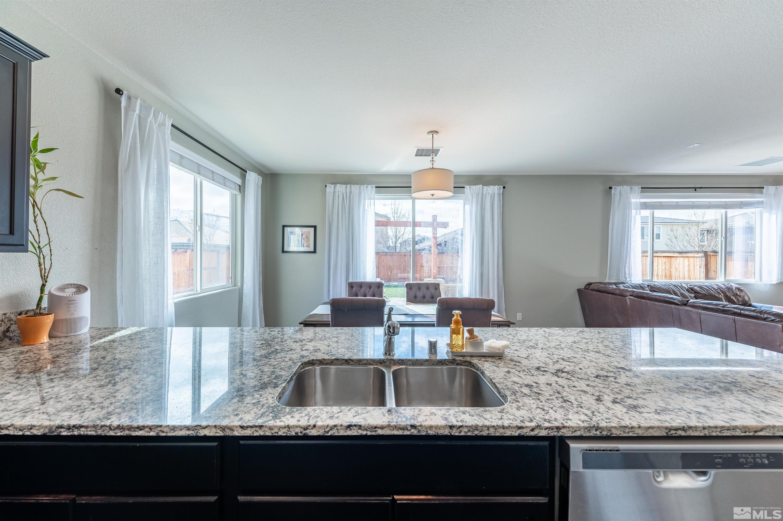 2980 Show Jumper Lane Reno, NV 89521 - Photo 7 of 15 a kitchen with granite countertop a sink a stove and cabinets