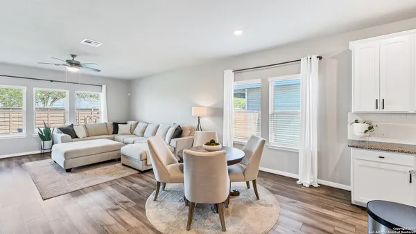 a view of a dining room with furniture window and wooden floor