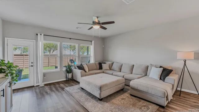a living room with furniture and a large window