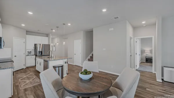 a kitchen with a table and chairs in it
