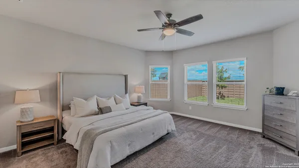 a bedroom with a large bed and a window