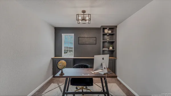 a workspace with furniture and window