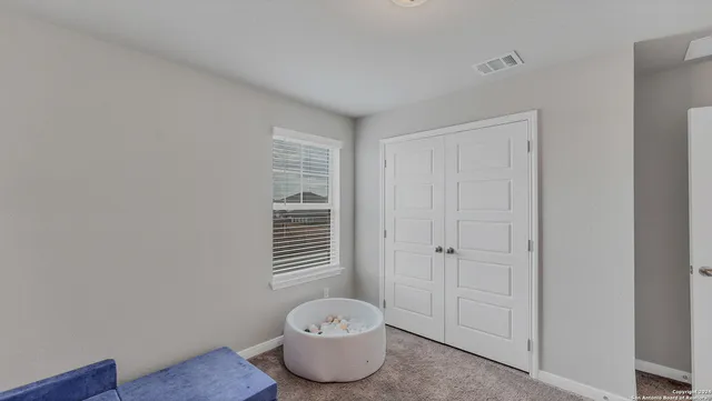 a bathroom with a toilet and a window