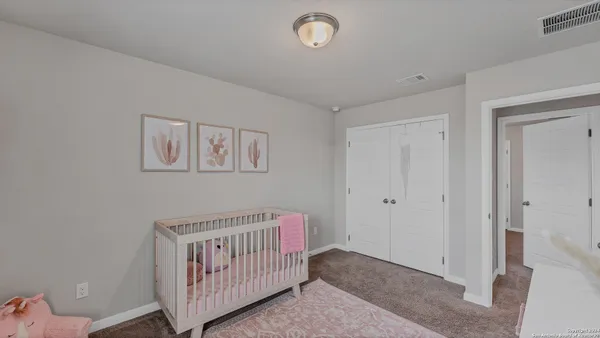a view of a room with furniture and baby crib