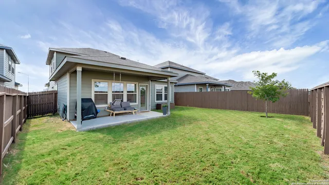 a view of a house with backyard and porch