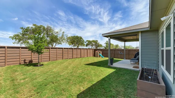 a view of a backyard with sitting area