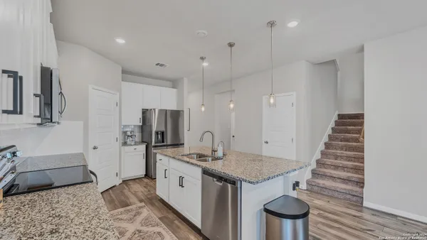 a kitchen with a sink and a refrigerator