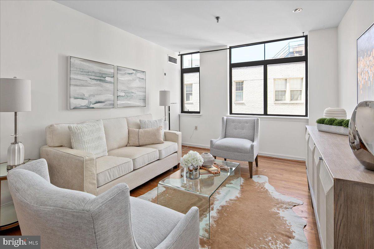 a living room with furniture and large window