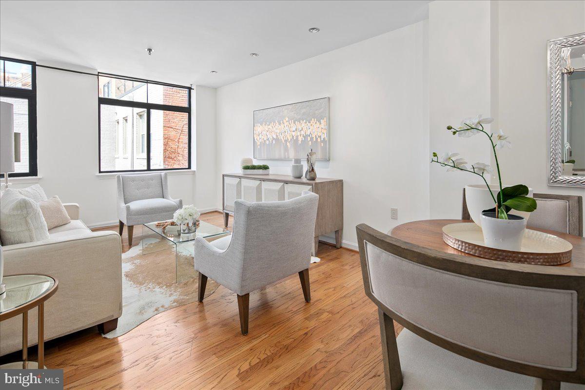 1312 Massachusetts Avenue Northwest, Unit 710 Washington, DC 20005 - Photo 12 of 30 a dining room with furniture potted plants and wooden floor