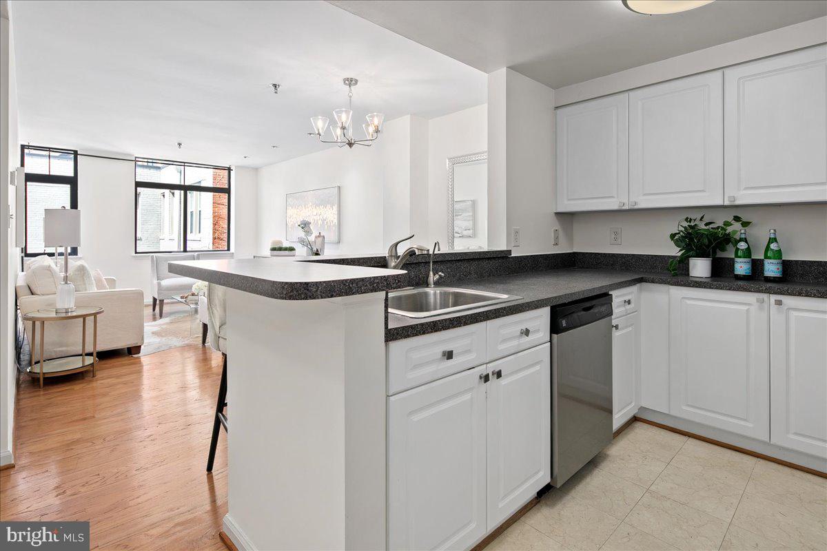 1312 Massachusetts Avenue Northwest, Unit 710 Washington, DC 20005 - Photo 14 of 30 a kitchen with granite countertop a sink and cabinets