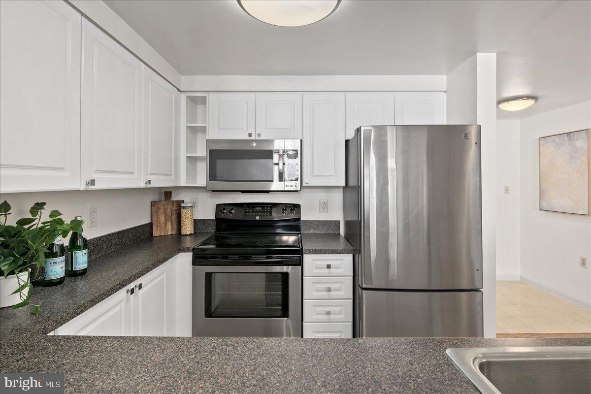 1312 Massachusetts Avenue Northwest, Unit 710 Washington, DC 20005 - Photo 16 of 30 a kitchen with a refrigerator sink and stove