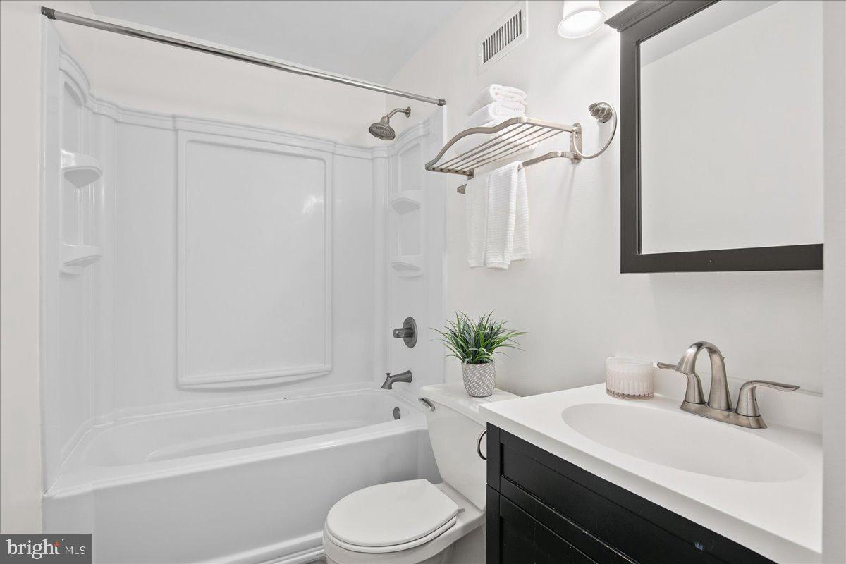 1312 Massachusetts Avenue Northwest, Unit 710 Washington, DC 20005 - Photo 18 of 30 a bathroom with a sink a toilet and shower