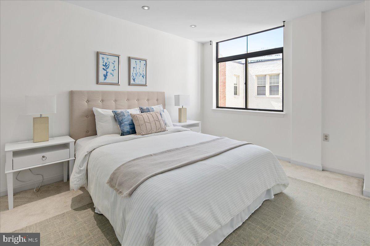 1312 Massachusetts Avenue Northwest, Unit 710 Washington, DC 20005 - Photo 22 of 30 a bedroom with a bed and a window