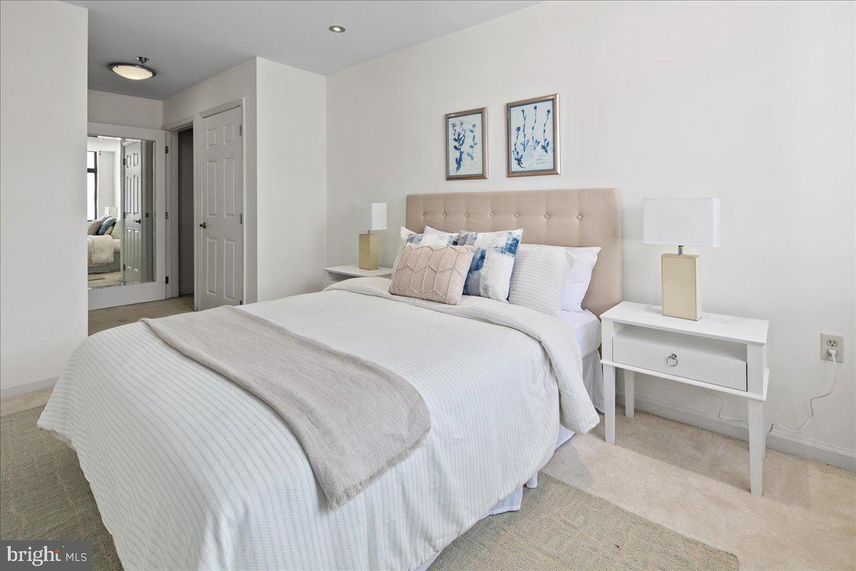 1312 Massachusetts Avenue Northwest, Unit 710 Washington, DC 20005 - Photo 23 of 30 a bedroom with a bed and a lamp