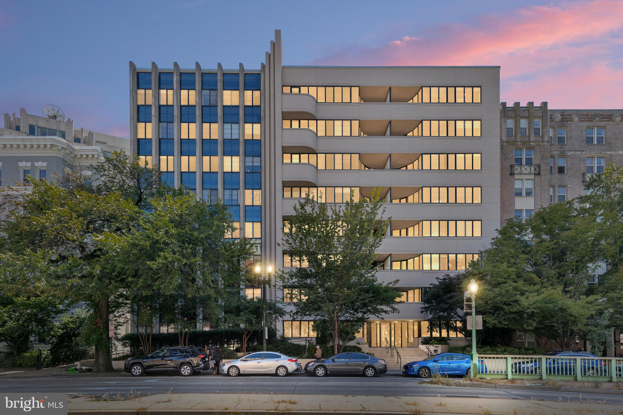 1312 Massachusetts Avenue Northwest, Unit 710 Washington, DC 20005 - Photo 30 of 30 a front view of multi story residential apartment building with yard and traffic signal