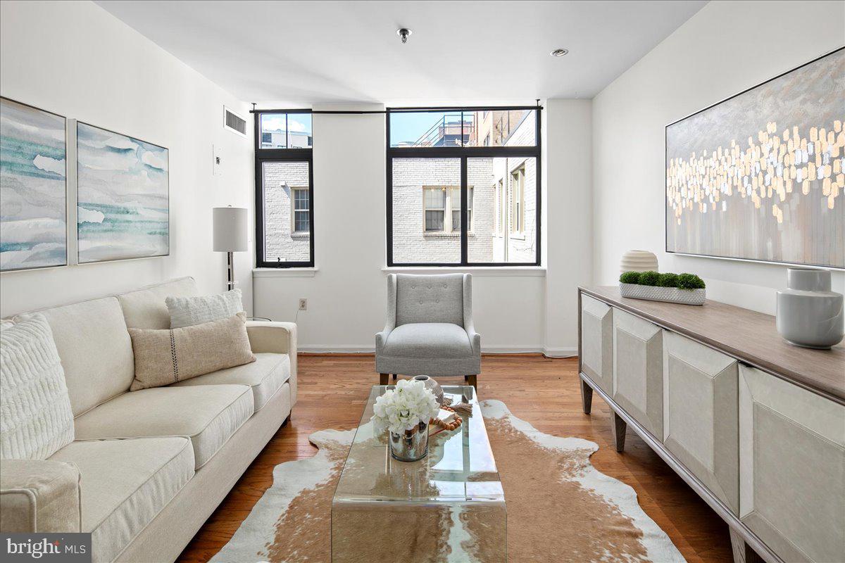 1312 Massachusetts Avenue Northwest, Unit 710 Washington, DC 20005 - Photo 4 of 30 a living room with furniture and large windows
