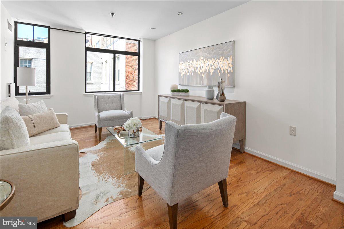 1312 Massachusetts Avenue Northwest, Unit 710 Washington, DC 20005 - Photo 6 of 30 a living room with furniture and a large window