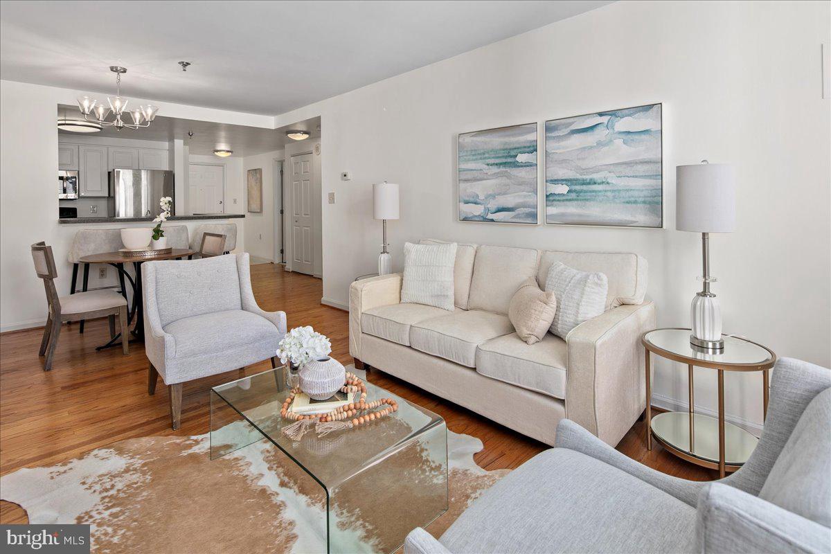 1312 Massachusetts Avenue Northwest, Unit 710 Washington, DC 20005 - Photo 7 of 30 a living room with furniture and a table