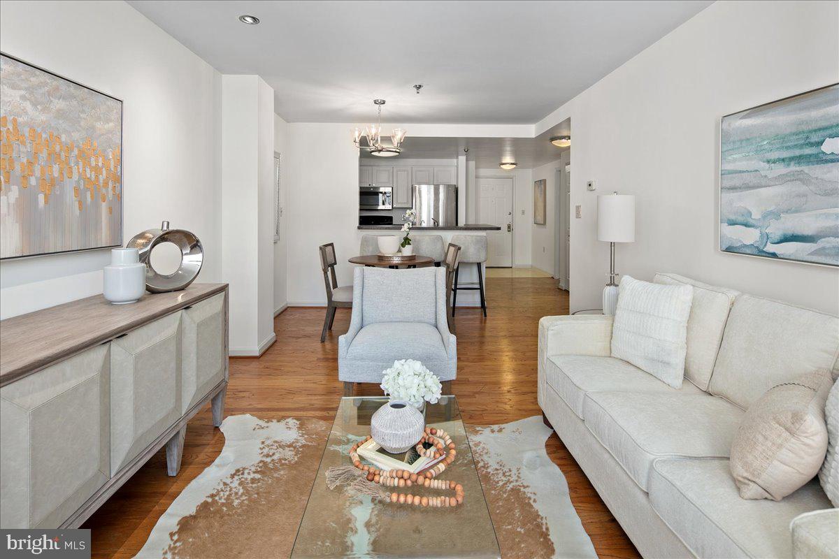 1312 Massachusetts Avenue Northwest, Unit 710 Washington, DC 20005 - Photo 8 of 30 a living room with furniture and a rug