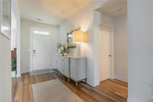 a dining room with furniture a chandelier and wooden floor