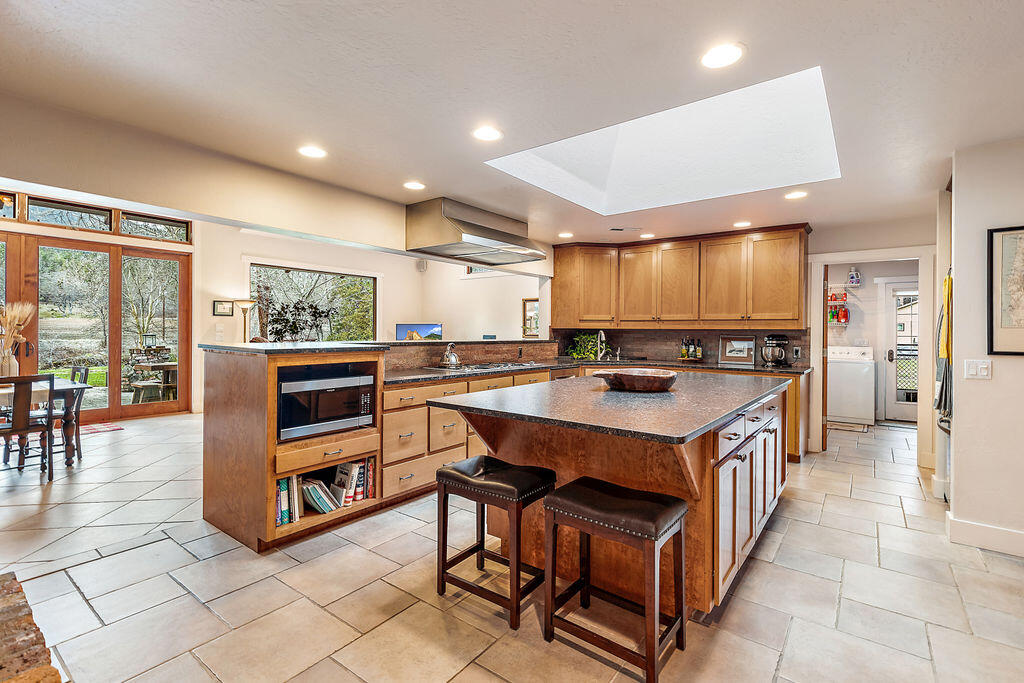 3828 Upper Applegate Road Jacksonville, OR 97530 - Photo 5 of 69 a kitchen with stainless steel appliances a stove a sink and a refrigerator